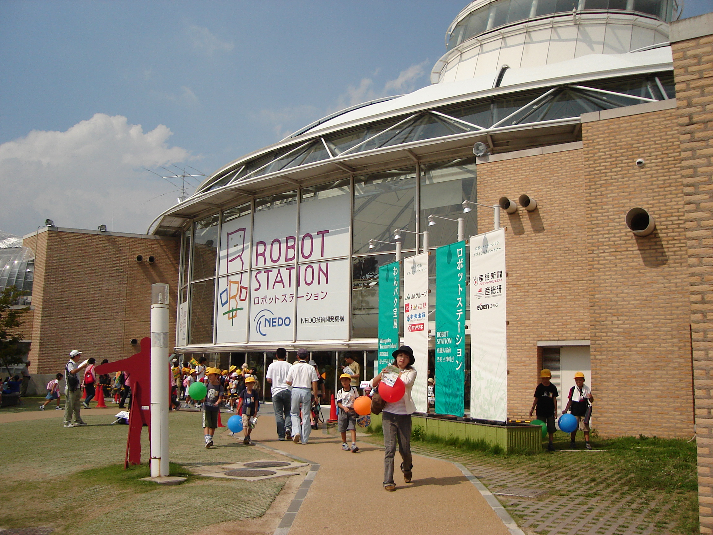 a building with a large robot station sign in the window