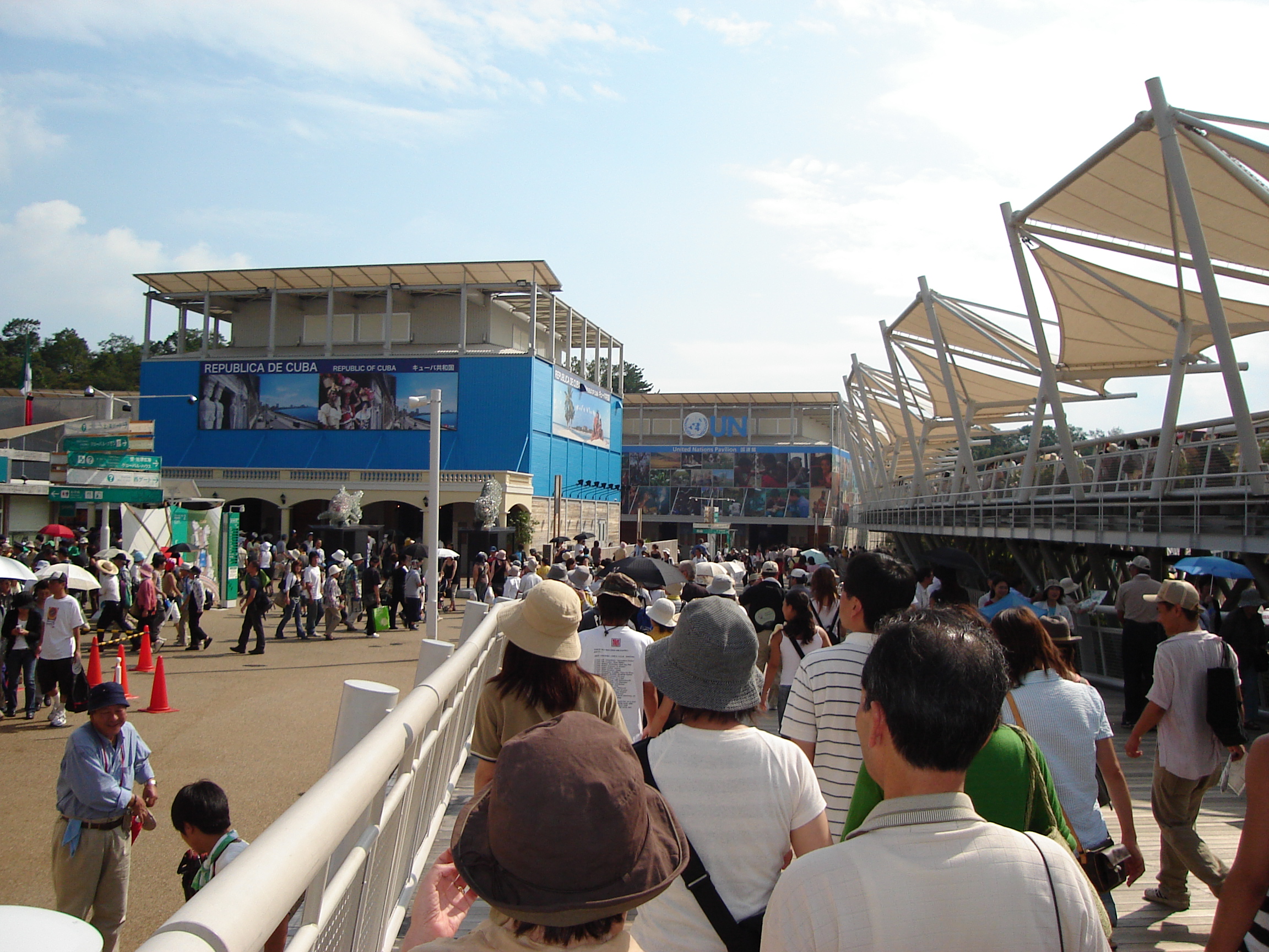 a crowd of people head toward some pavillions