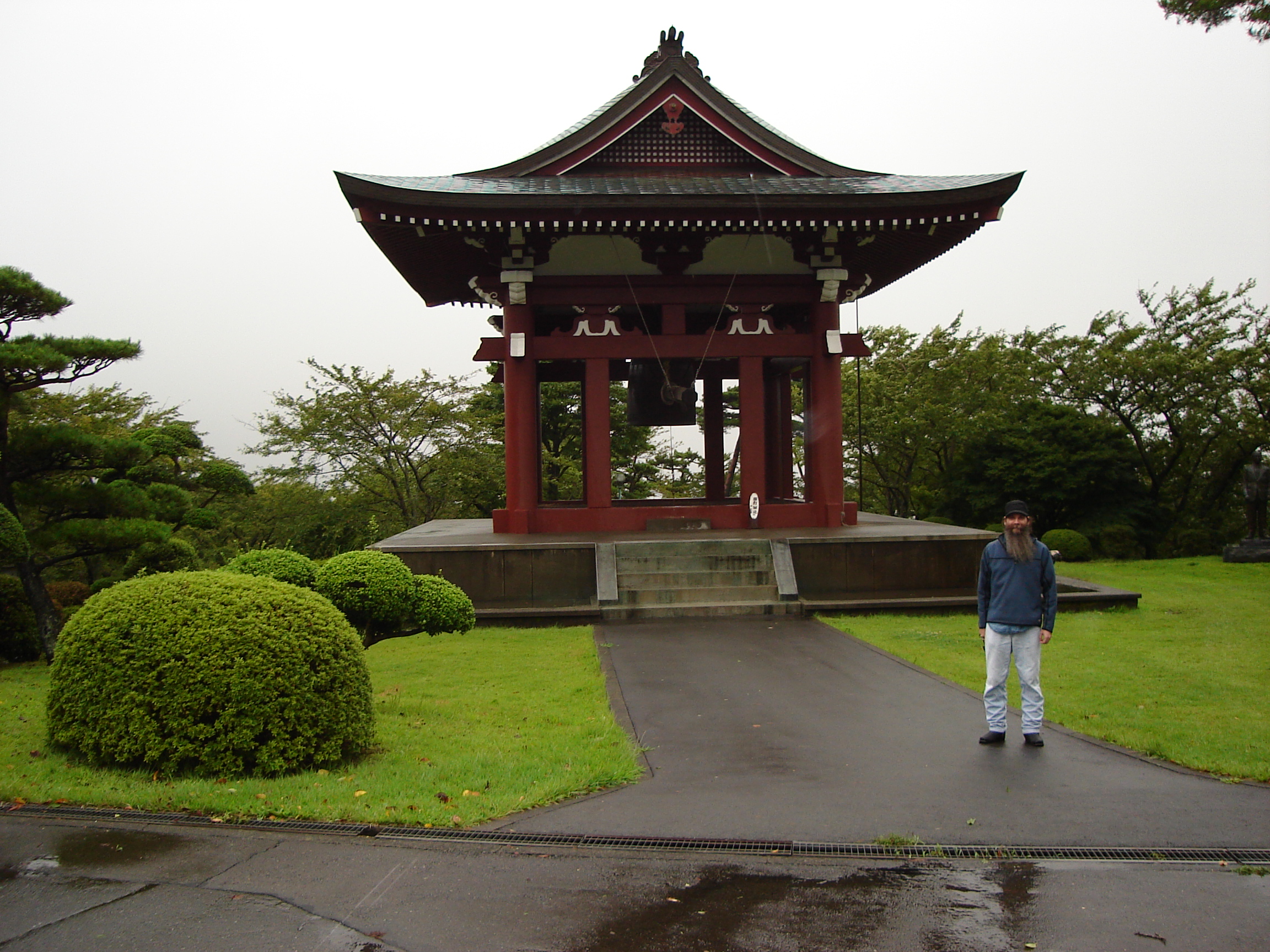 selfie near a small pagoda with large metal bell