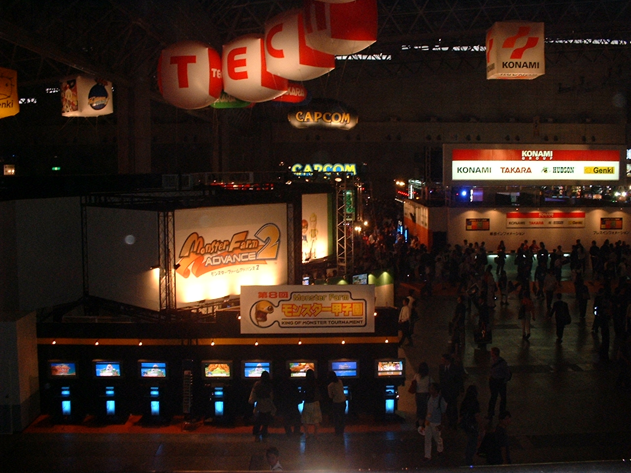 balloons spell out the tecmo logo above their booth