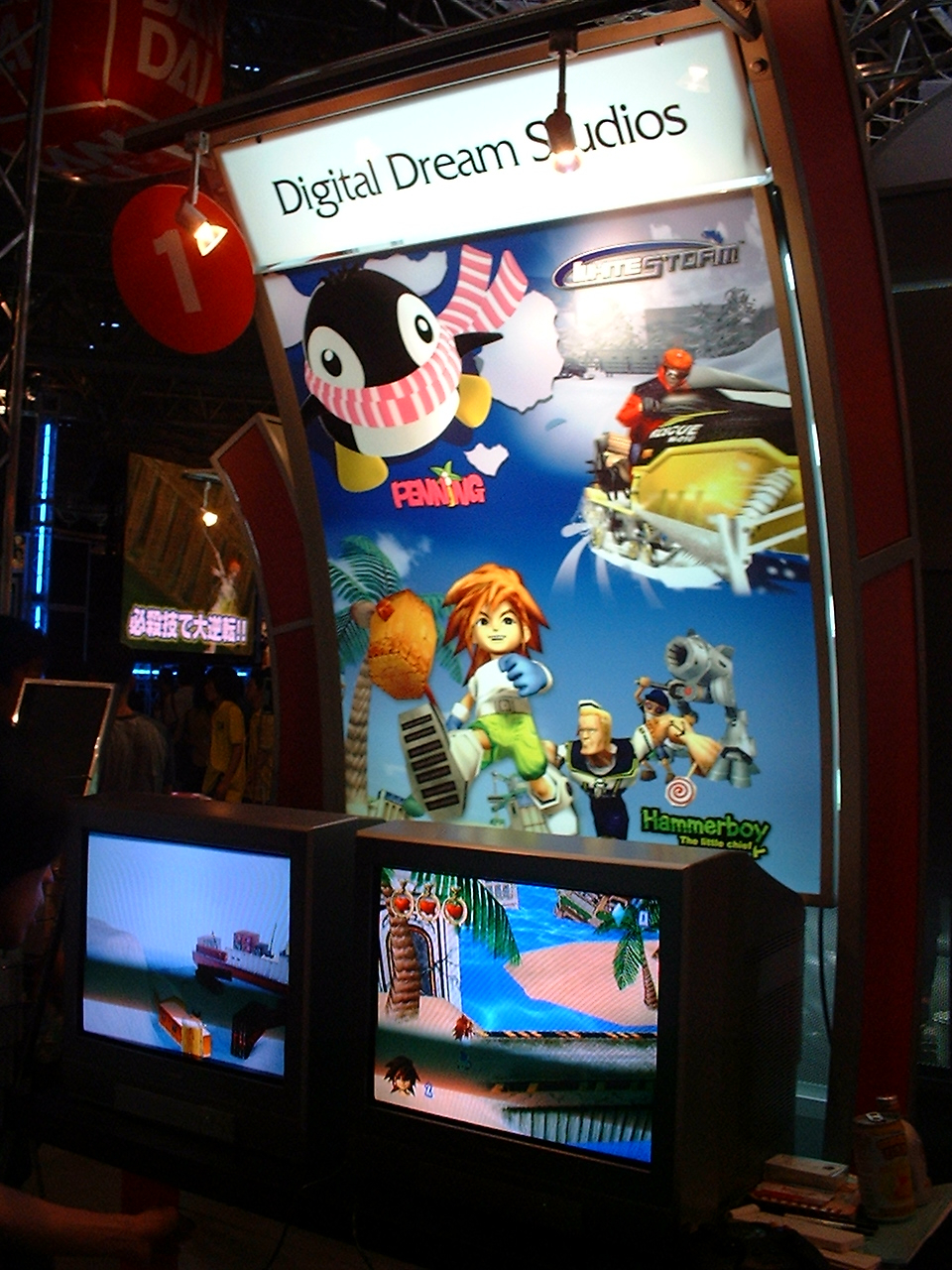 tvs in front of a poster with a penguin on it