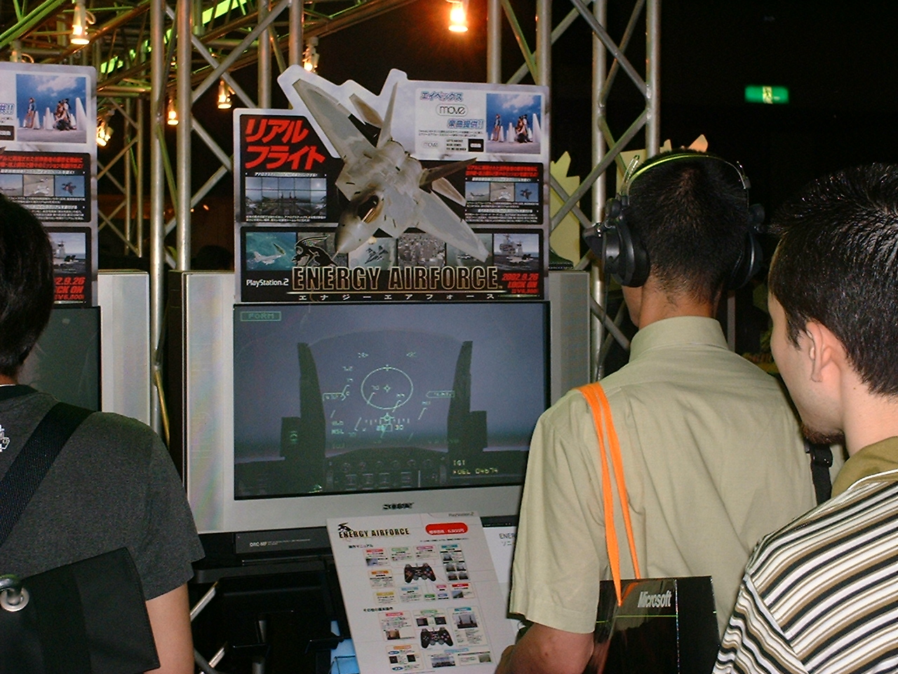 a japanese man wears headphones as he plays energy aitforce