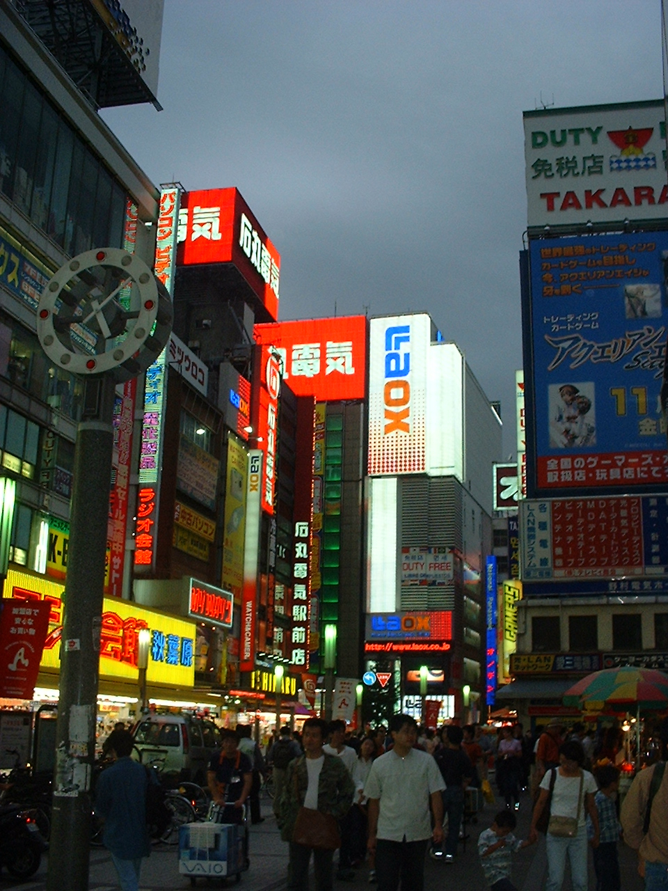 various building signs lit at dusk