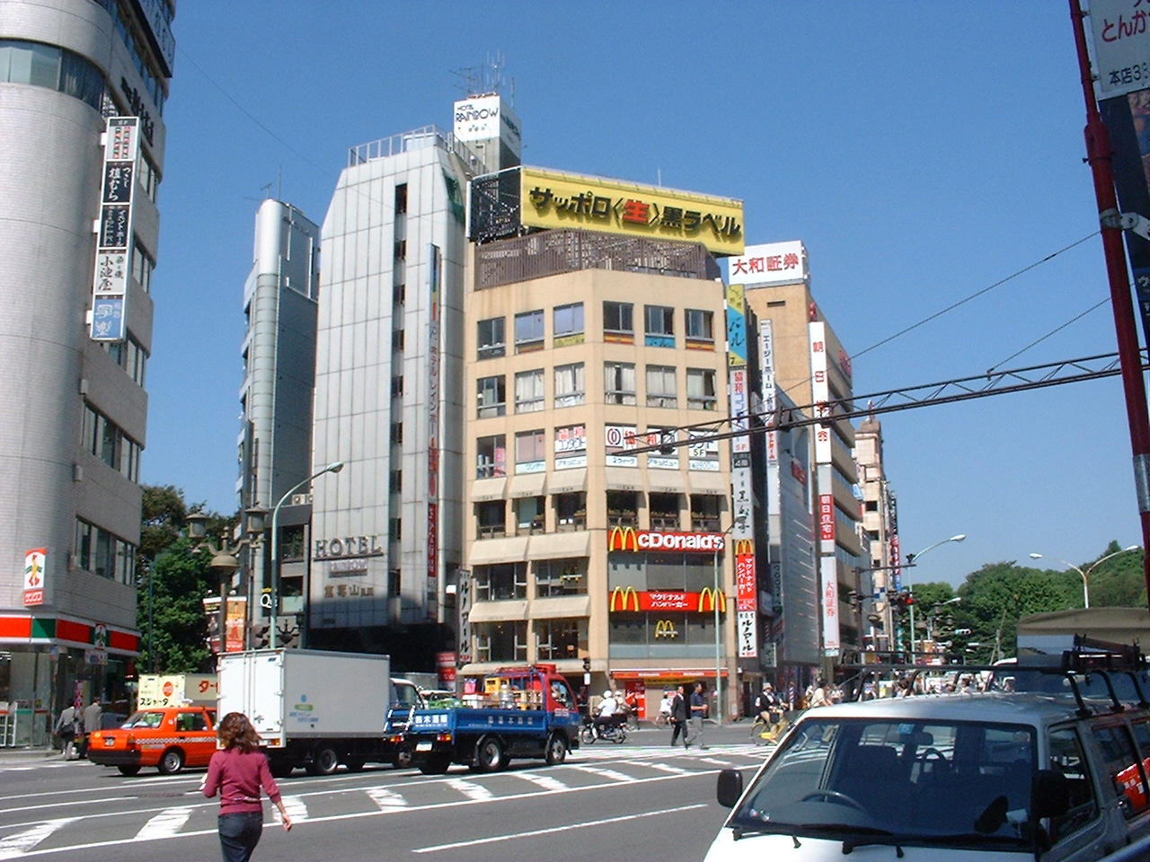 a beige building with a mcdonald's restaurant on the first three floors