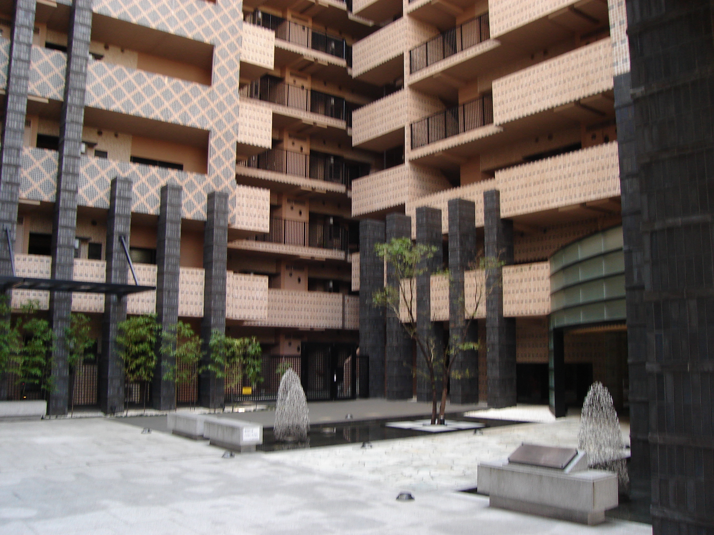 more plants and a water fountain in the building's courtyard