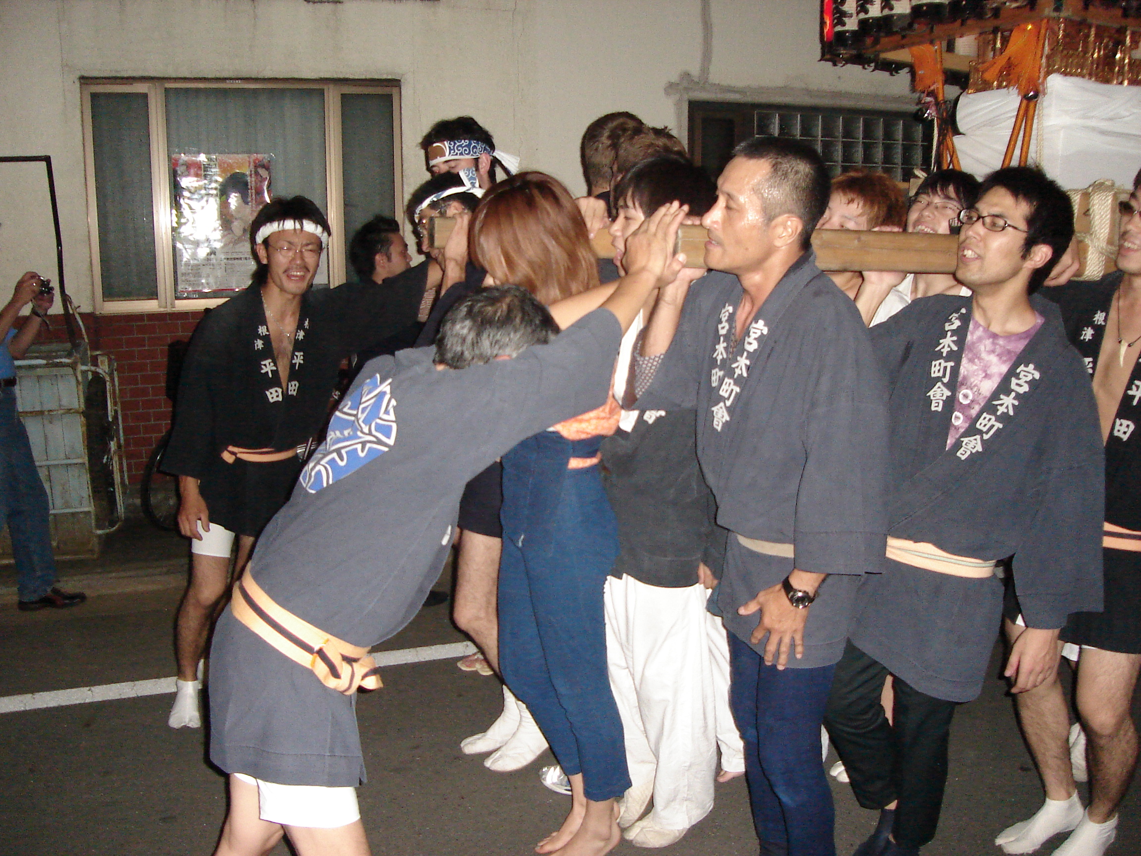 a man at the front of the procession turns and gets them to stop momentarily