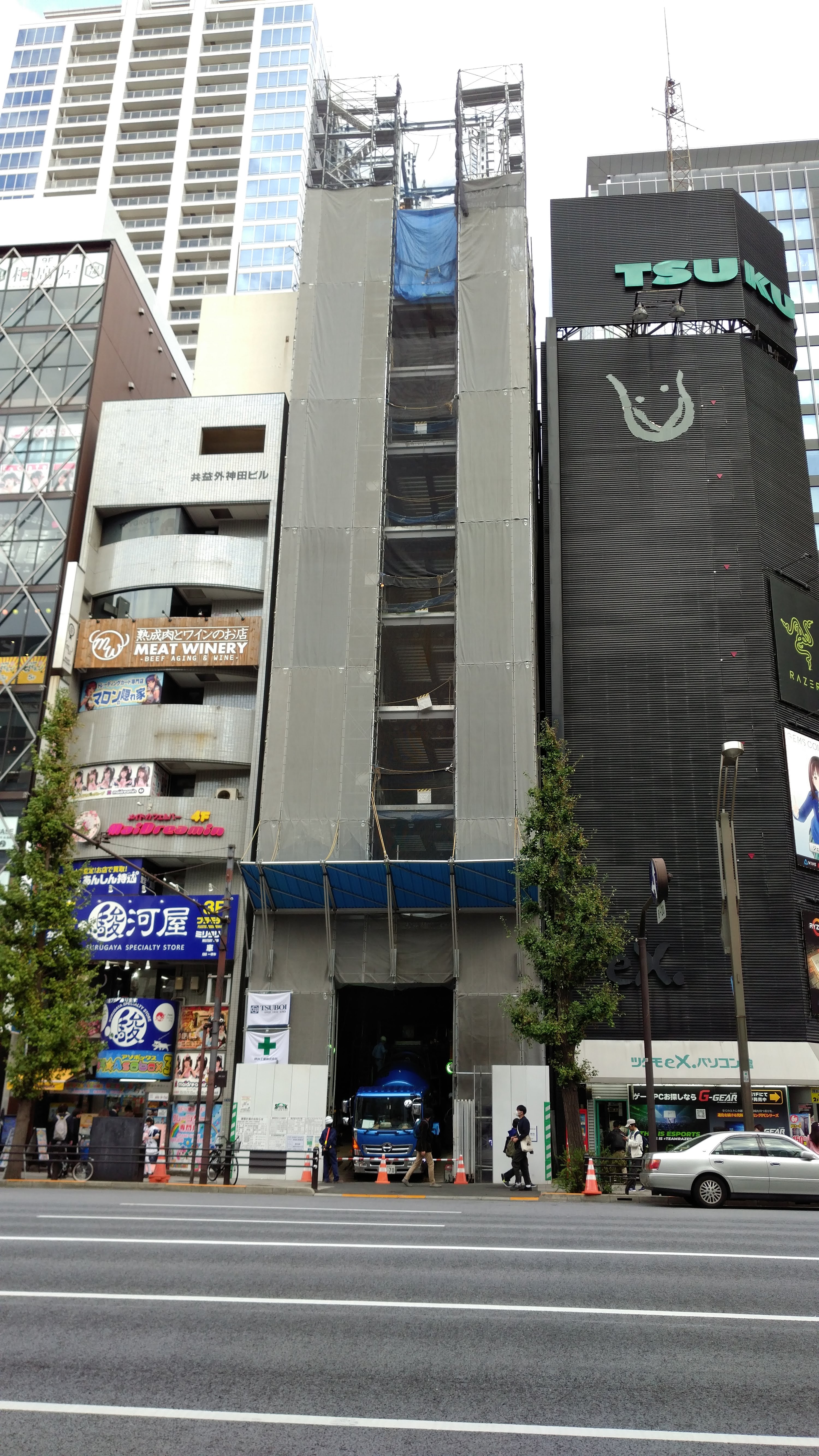 tall, skinny buildings, one is under renovation