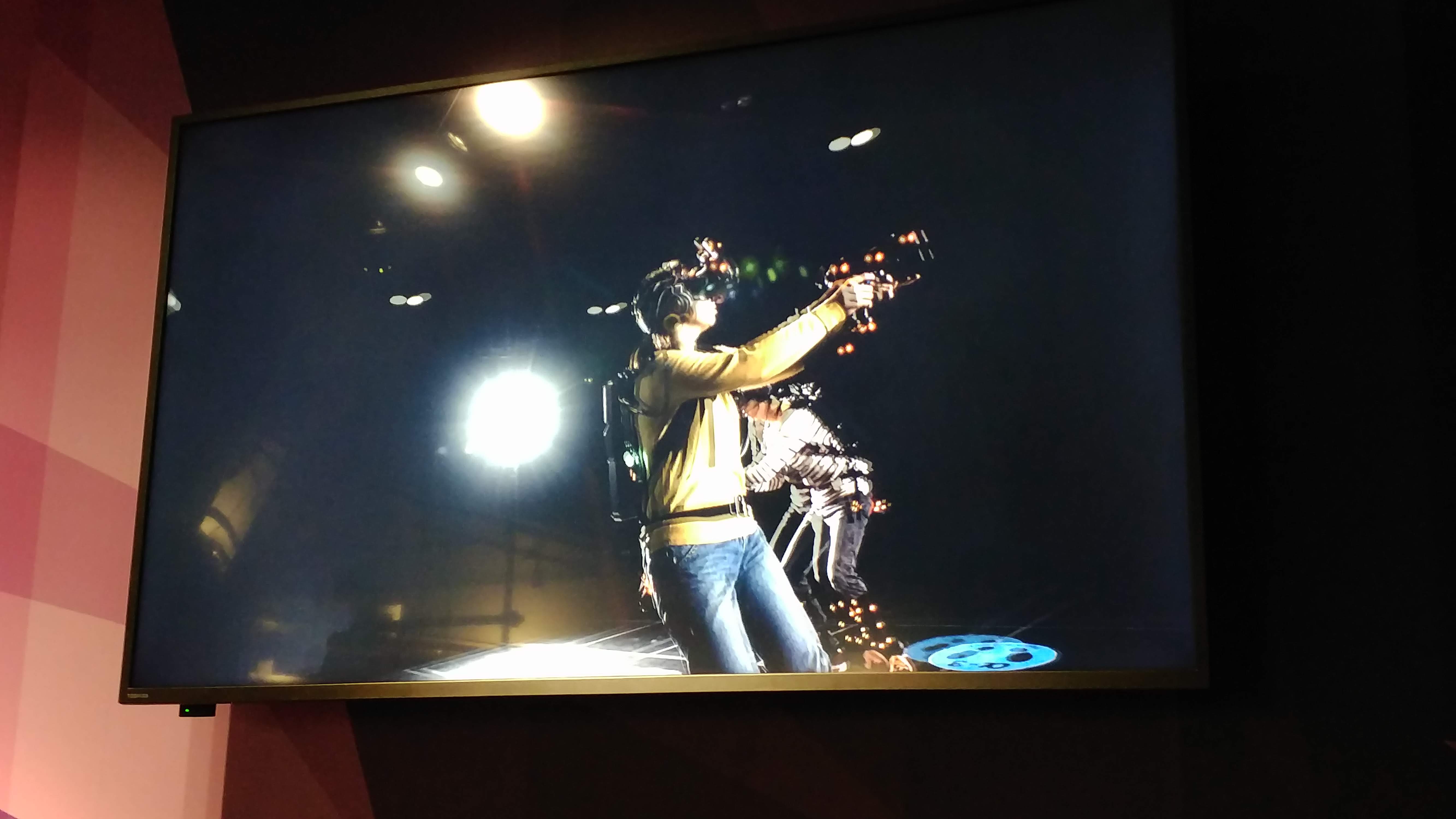 a screen showing people playing the VR game