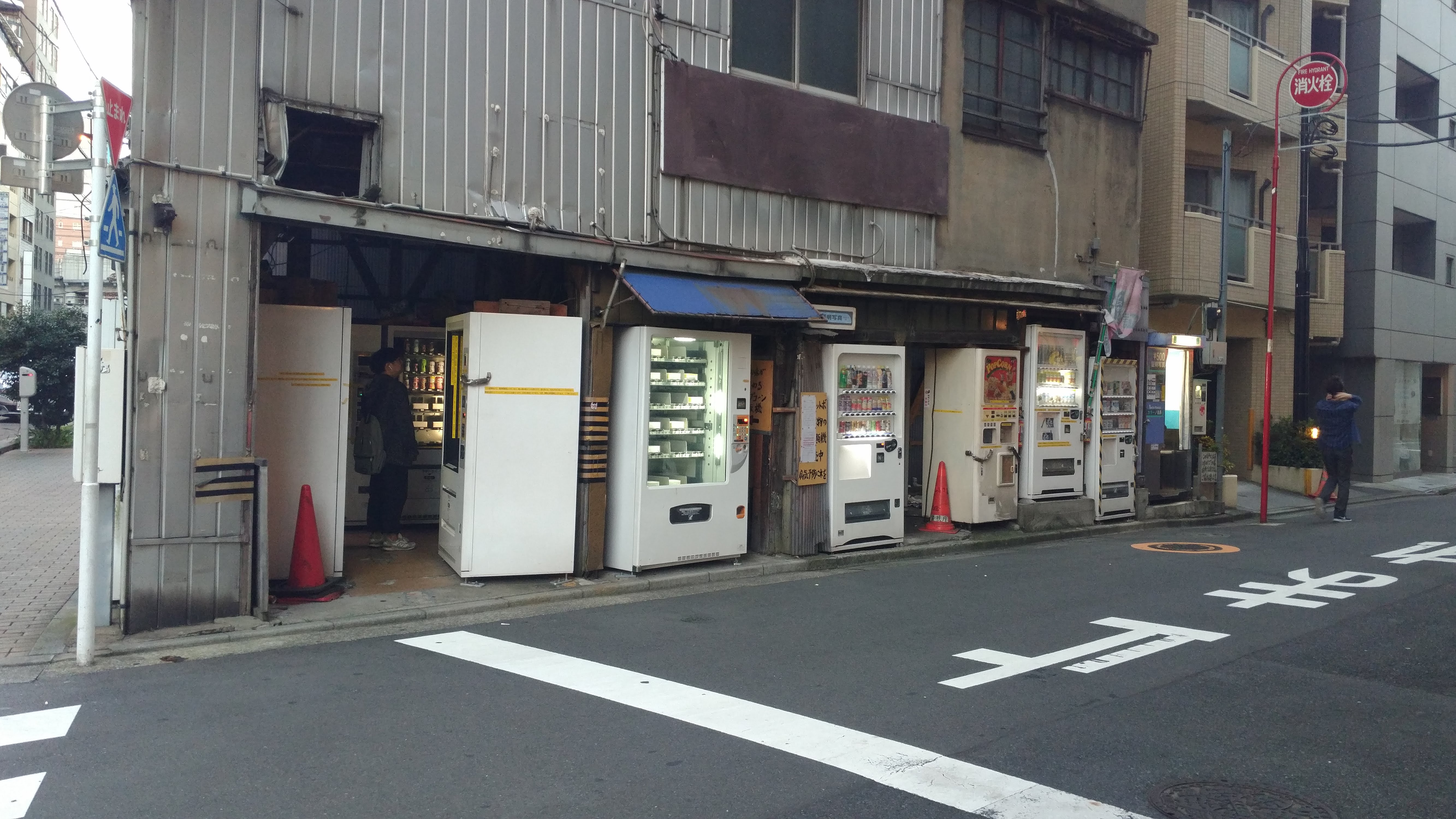 a series of run down looking white vending machines