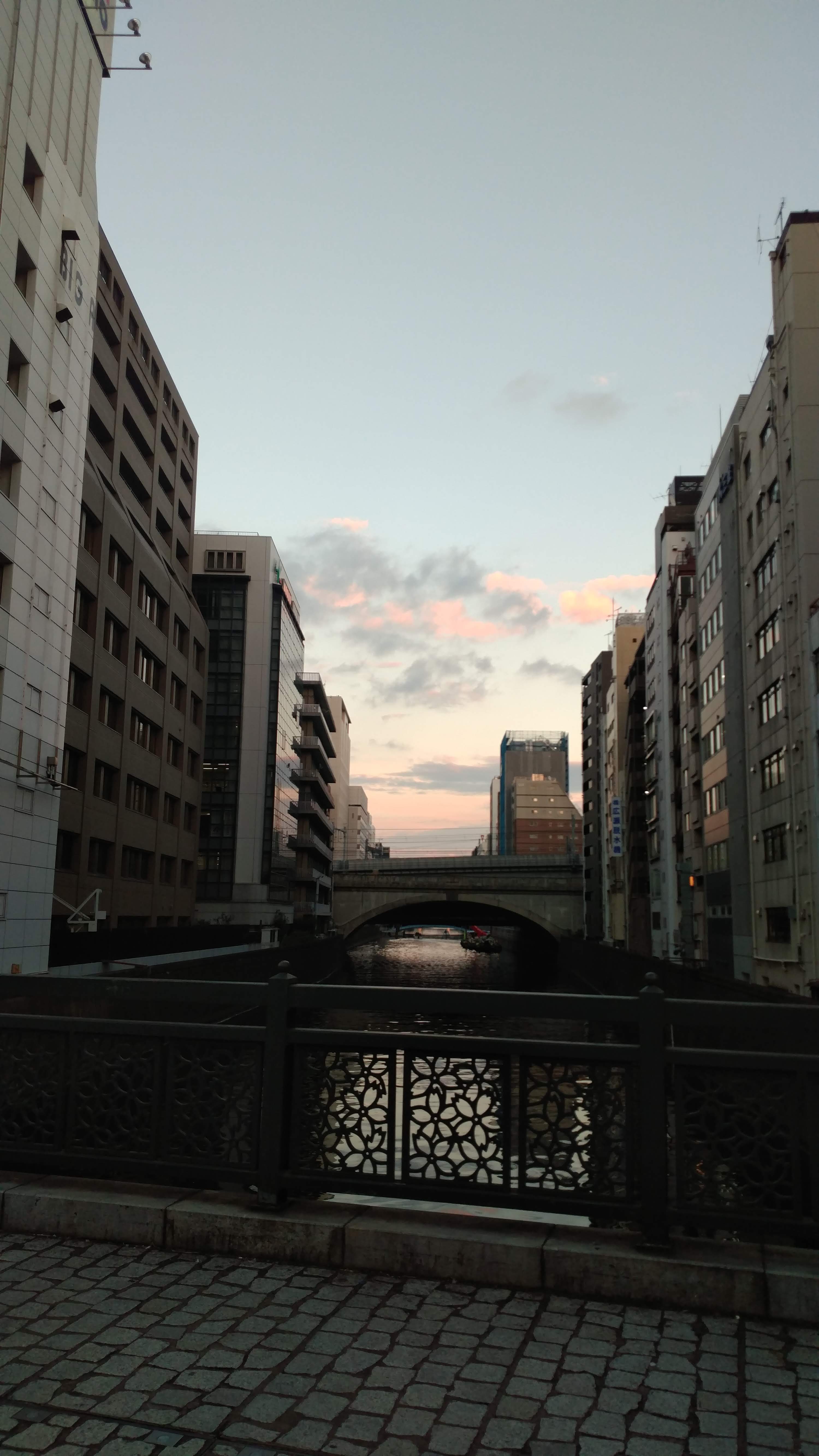 view from one bridge to another with buildings on both sides