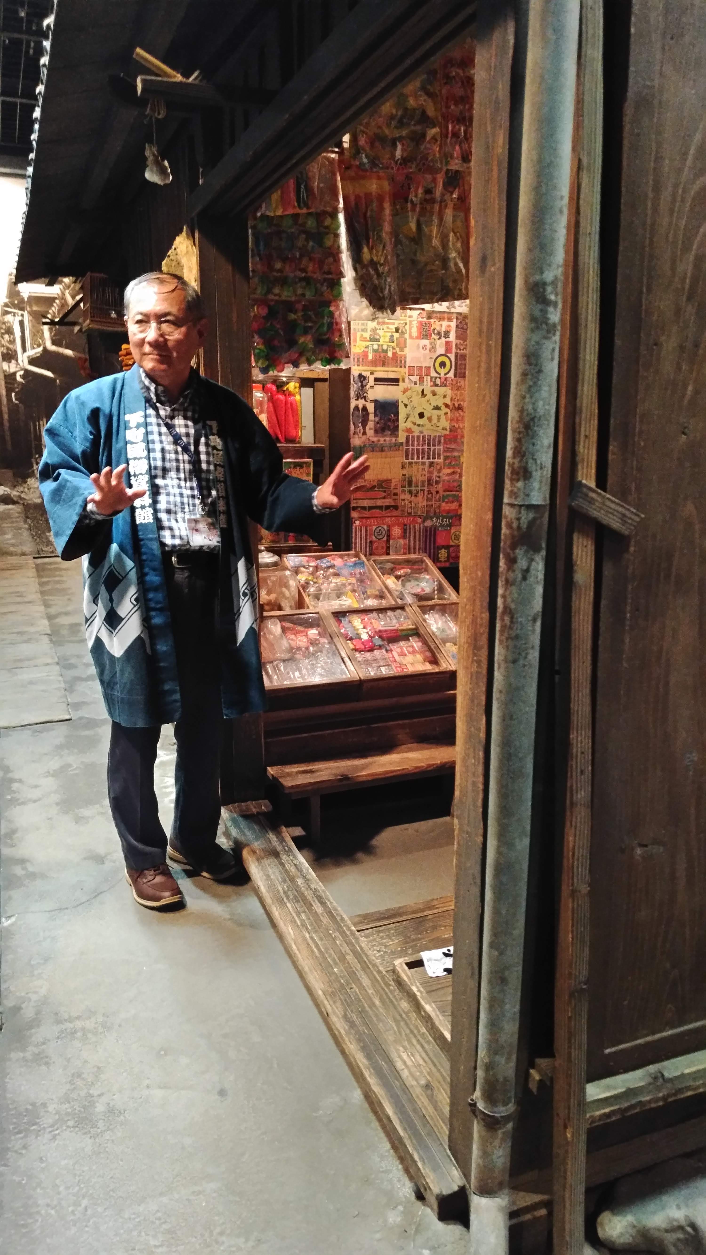 tour guide presenting an old store display