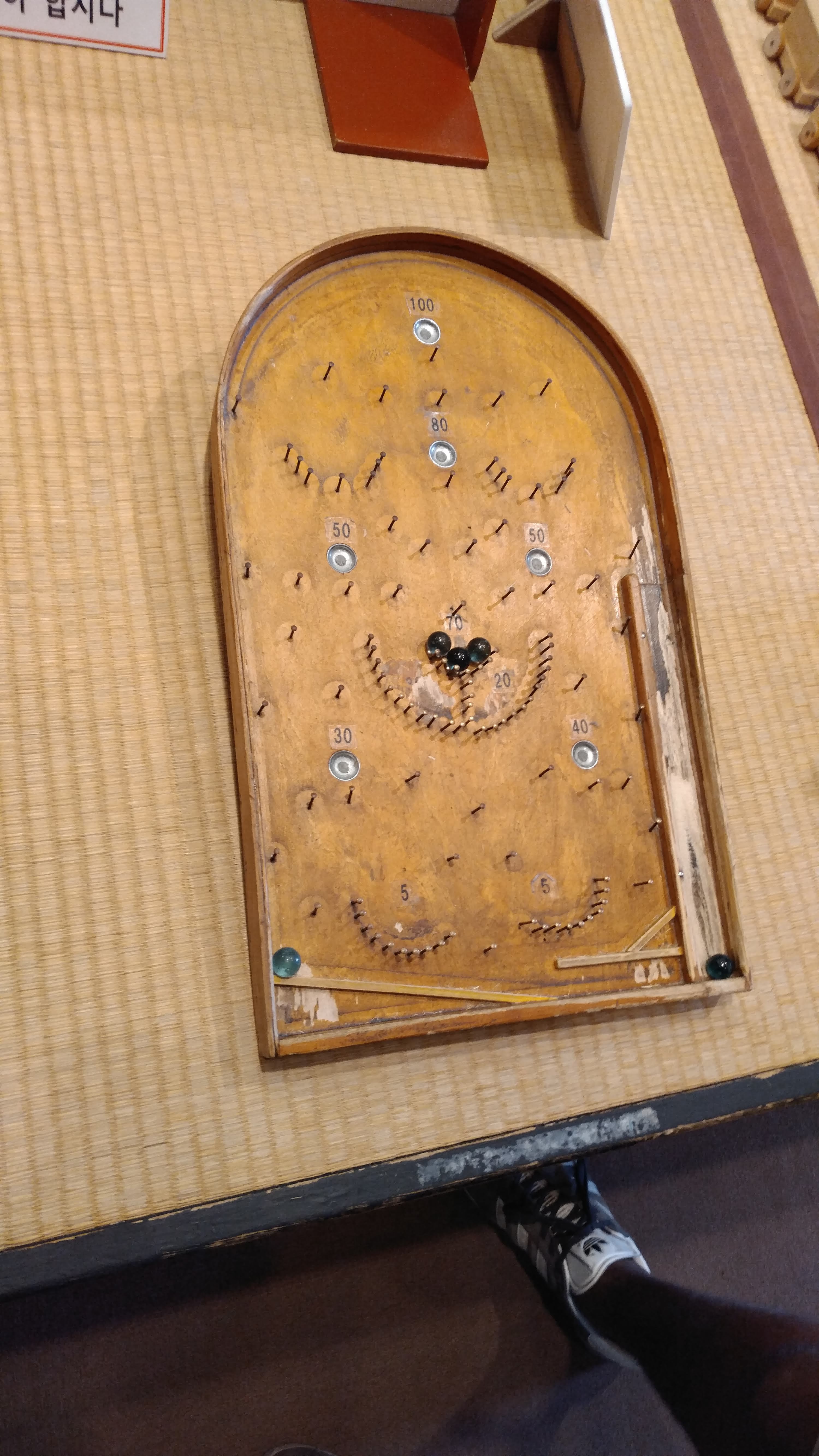 an old wooden pachinko type game