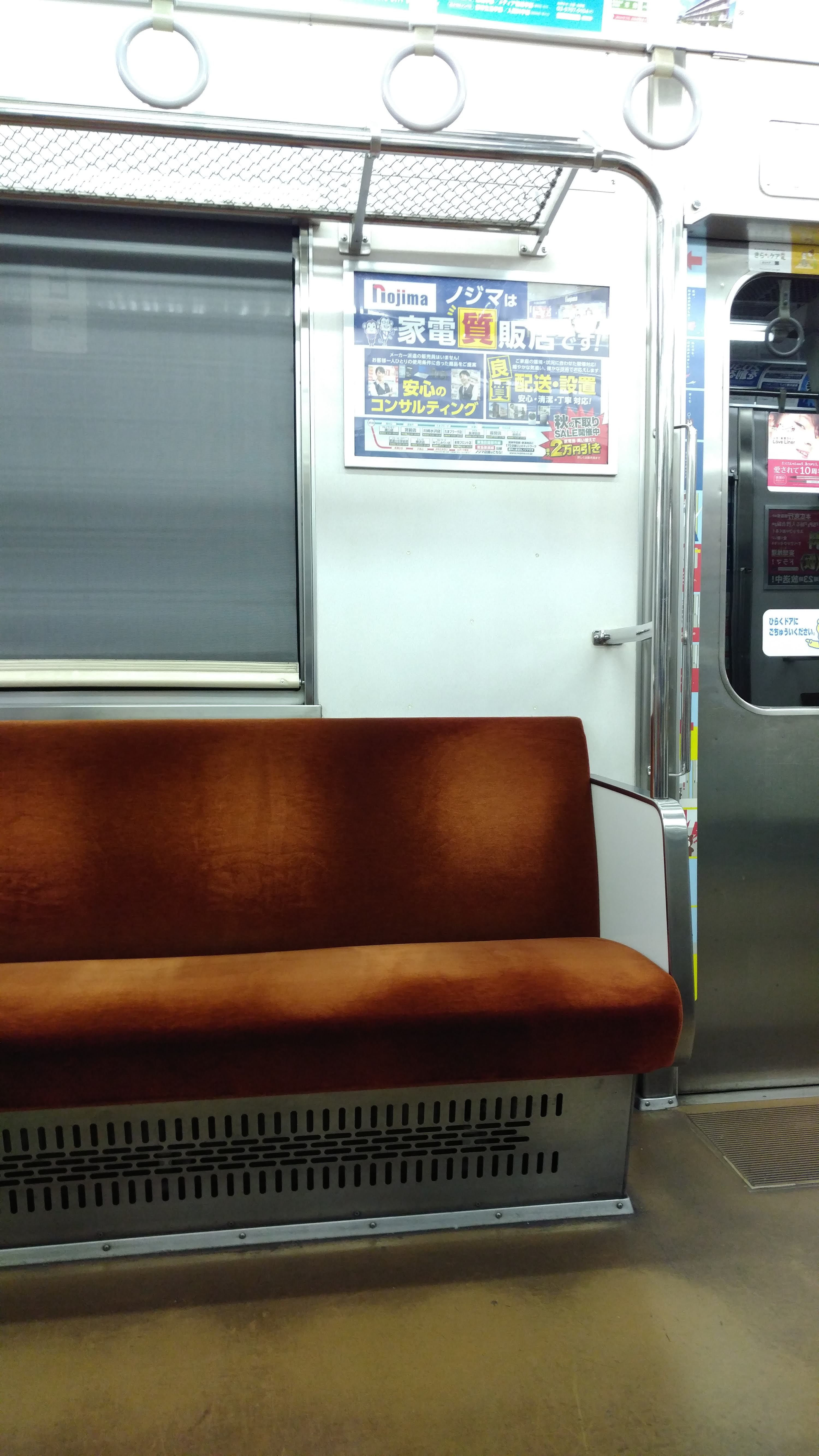 interior of an old subway car with amber cloth seating