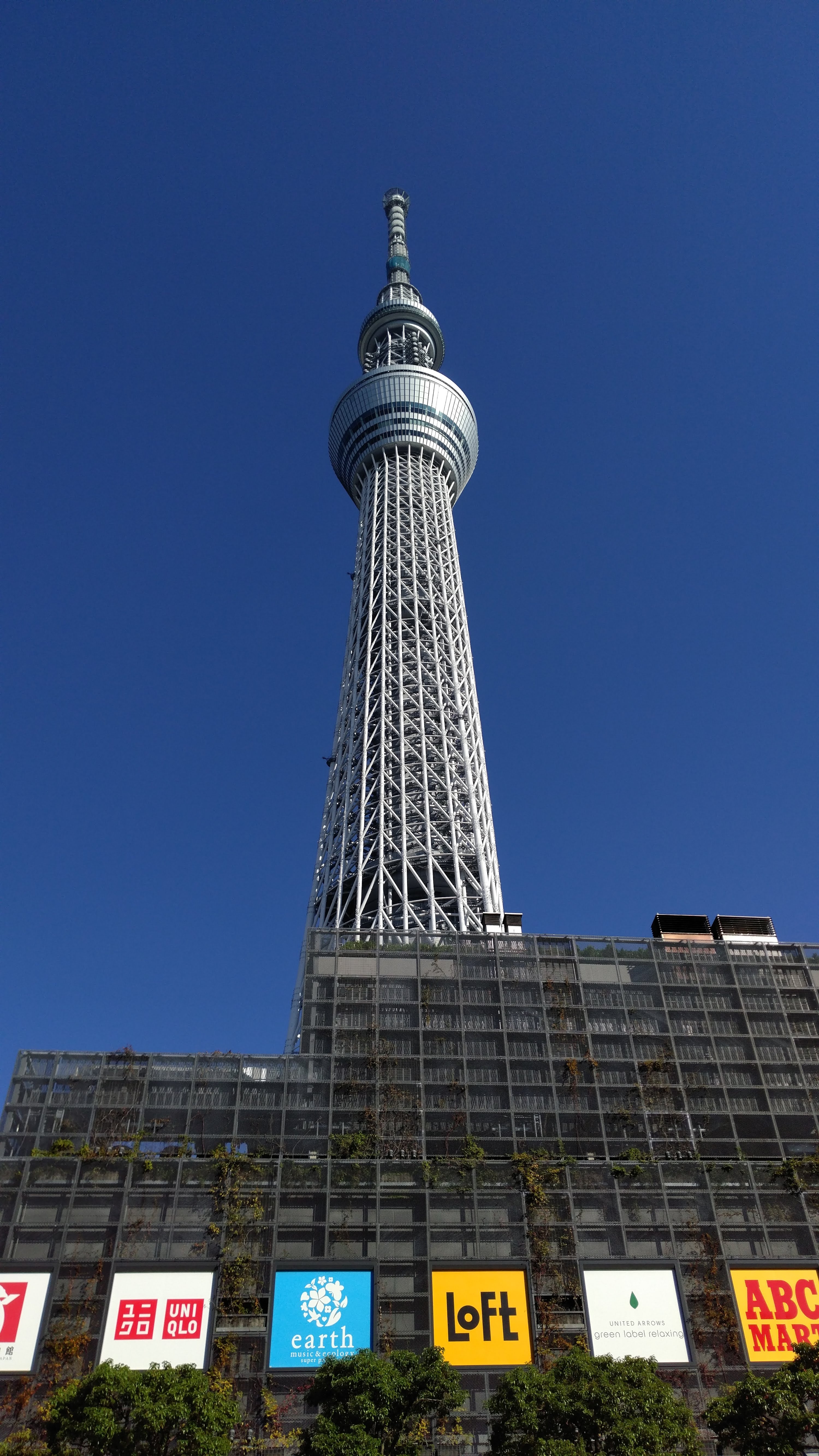 view of tokyo tower partially obscured by its shopping mall