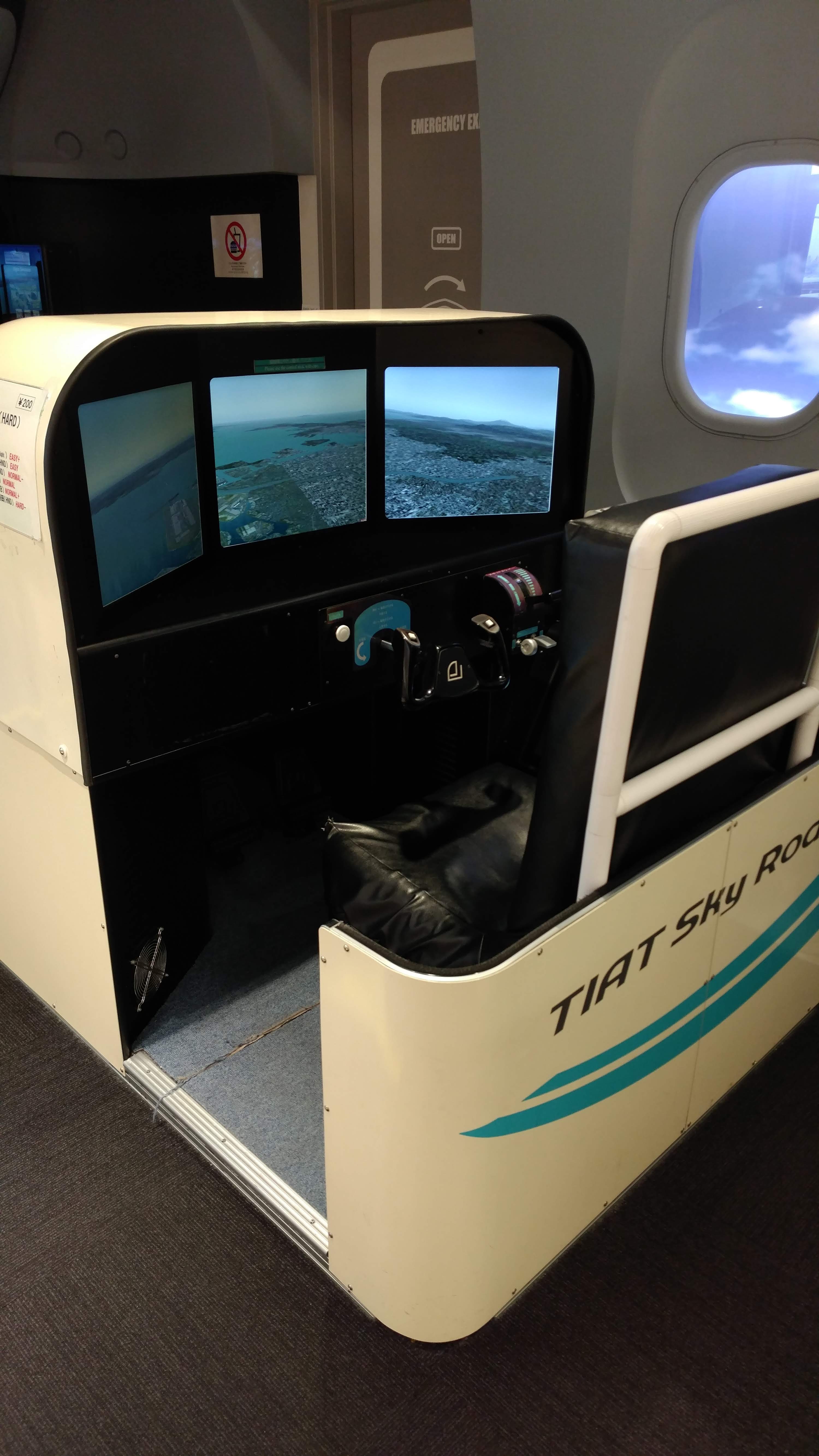 a plane flying simulator with a seat and three screens