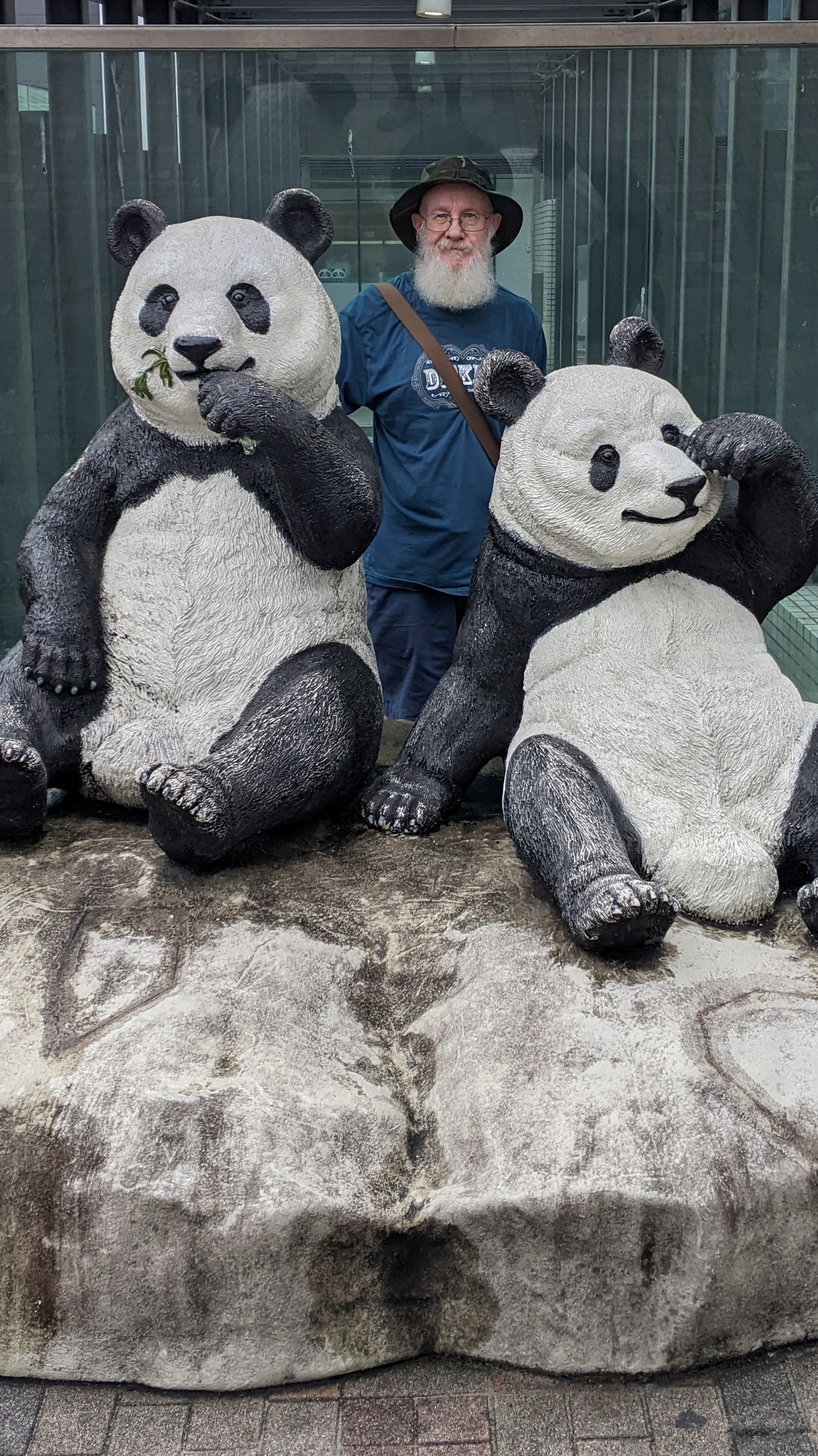 Chris behind a statue of two pandas