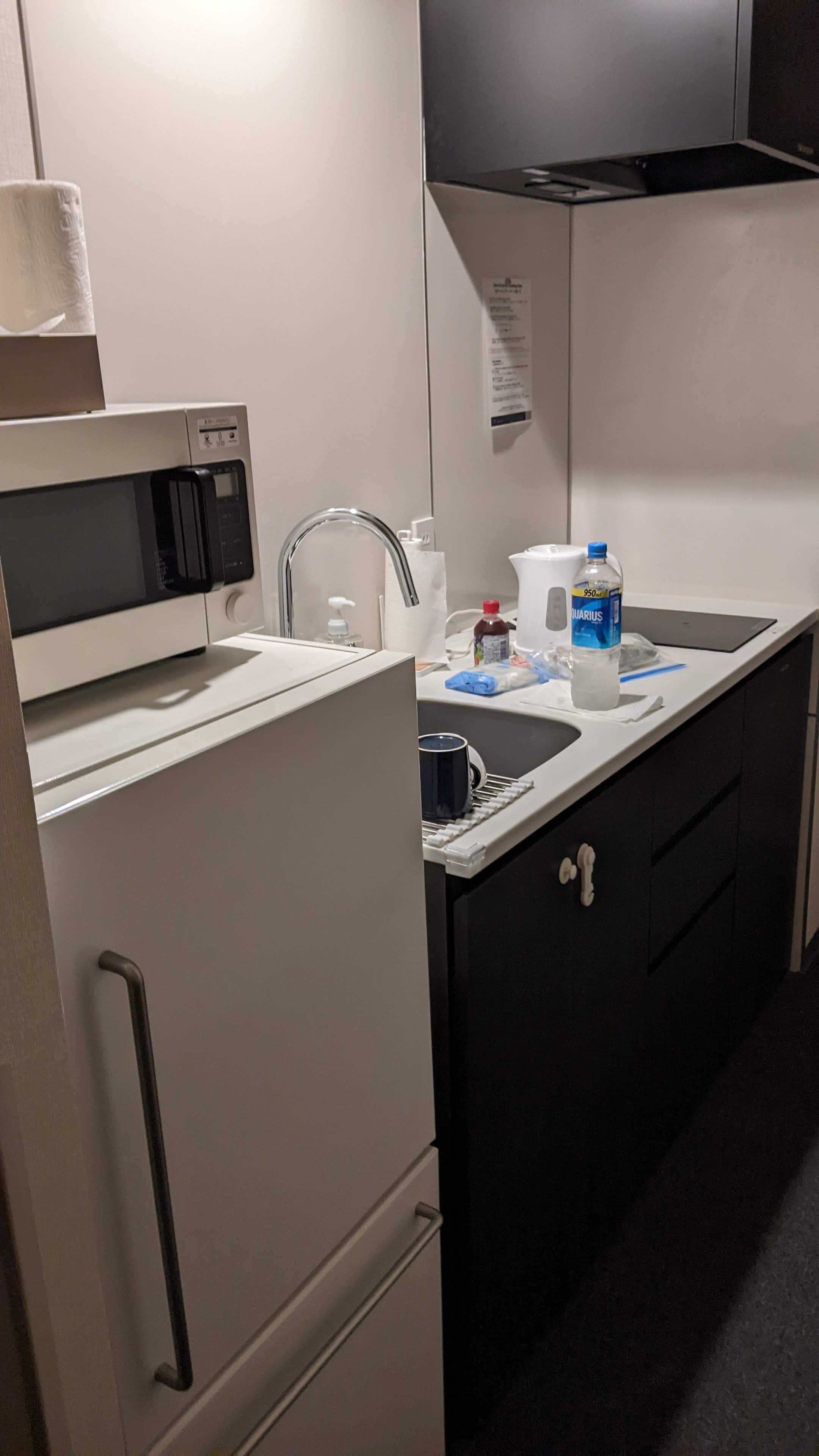 galley kitchenette with fridge, microwave, sink, and induction stovetop