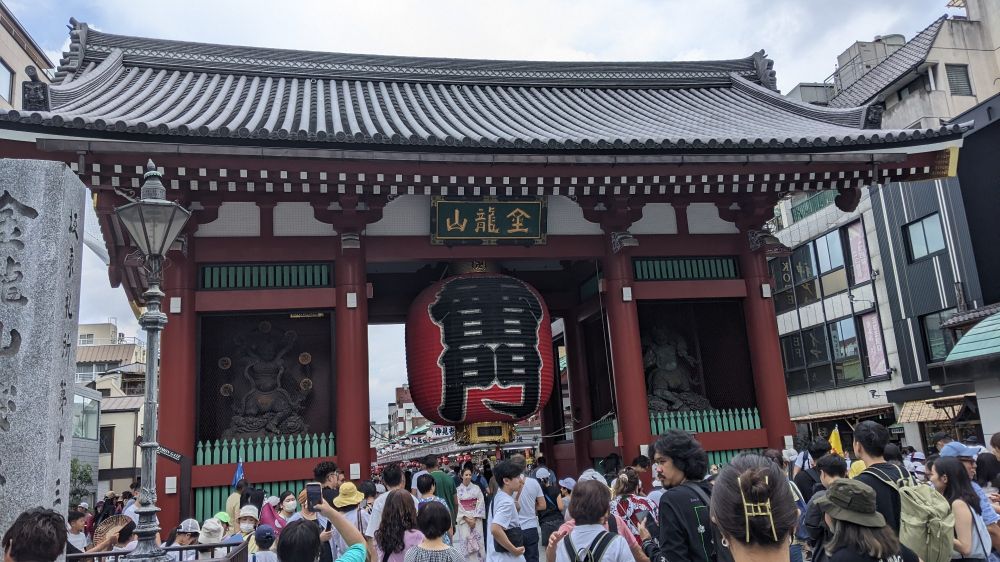 Large roofed entrance with large lantern and statues on either side