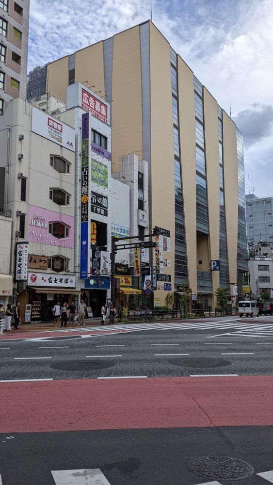 Buildings of various sizes next to each other.  One has hexagon windows.