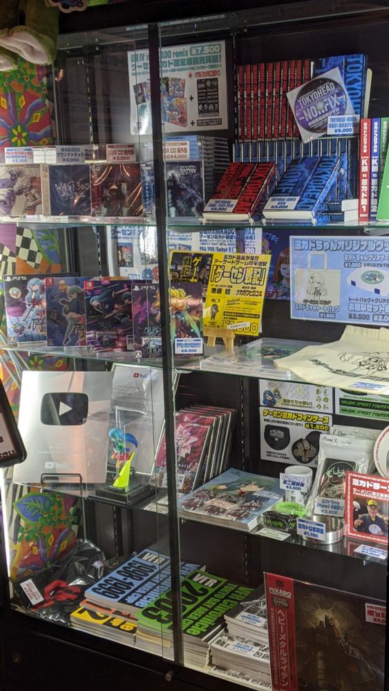 Display case of books and a Youtube subscriber award