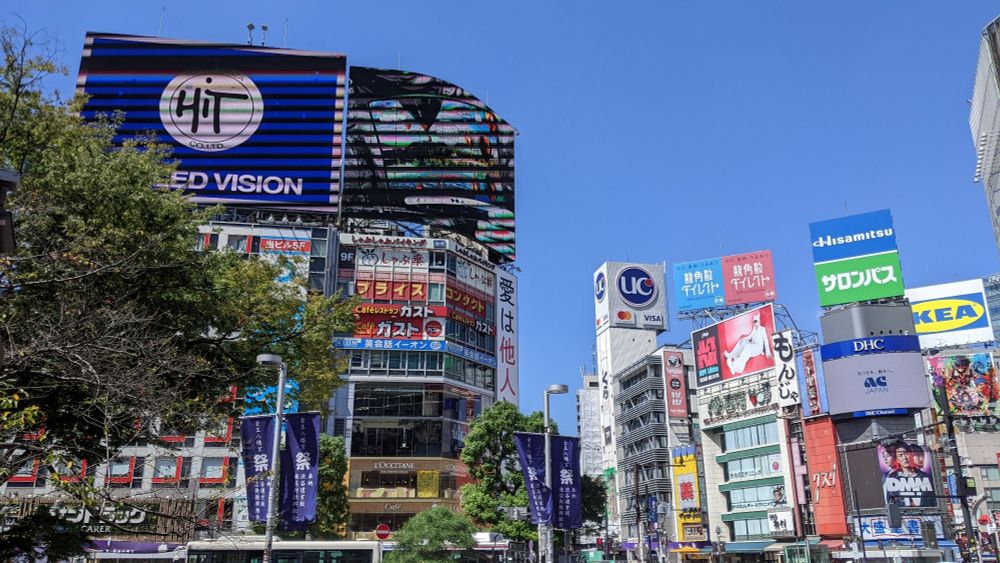 Large screens on top of buildings that dwarf other buildings