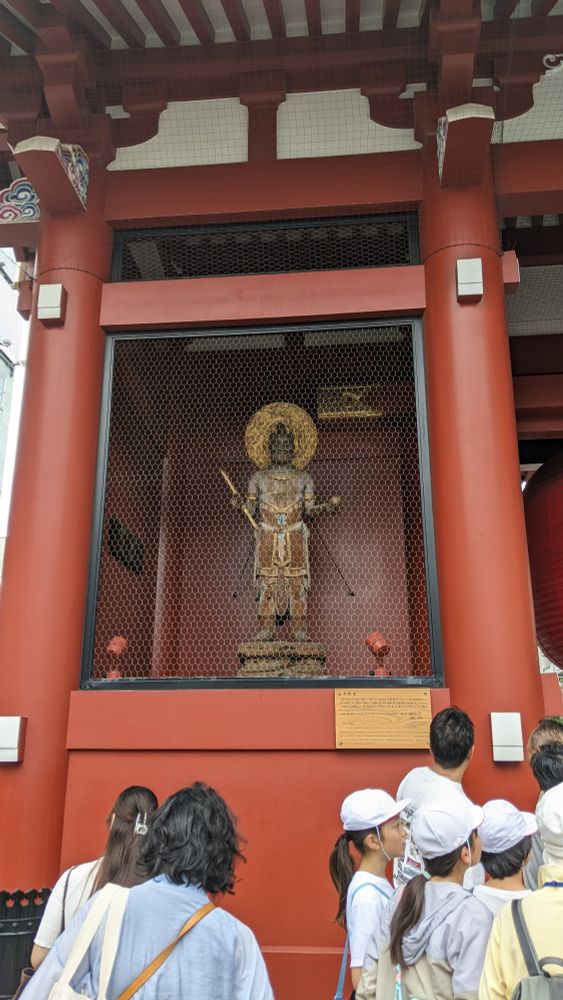 One of the entrance statues behind a grate