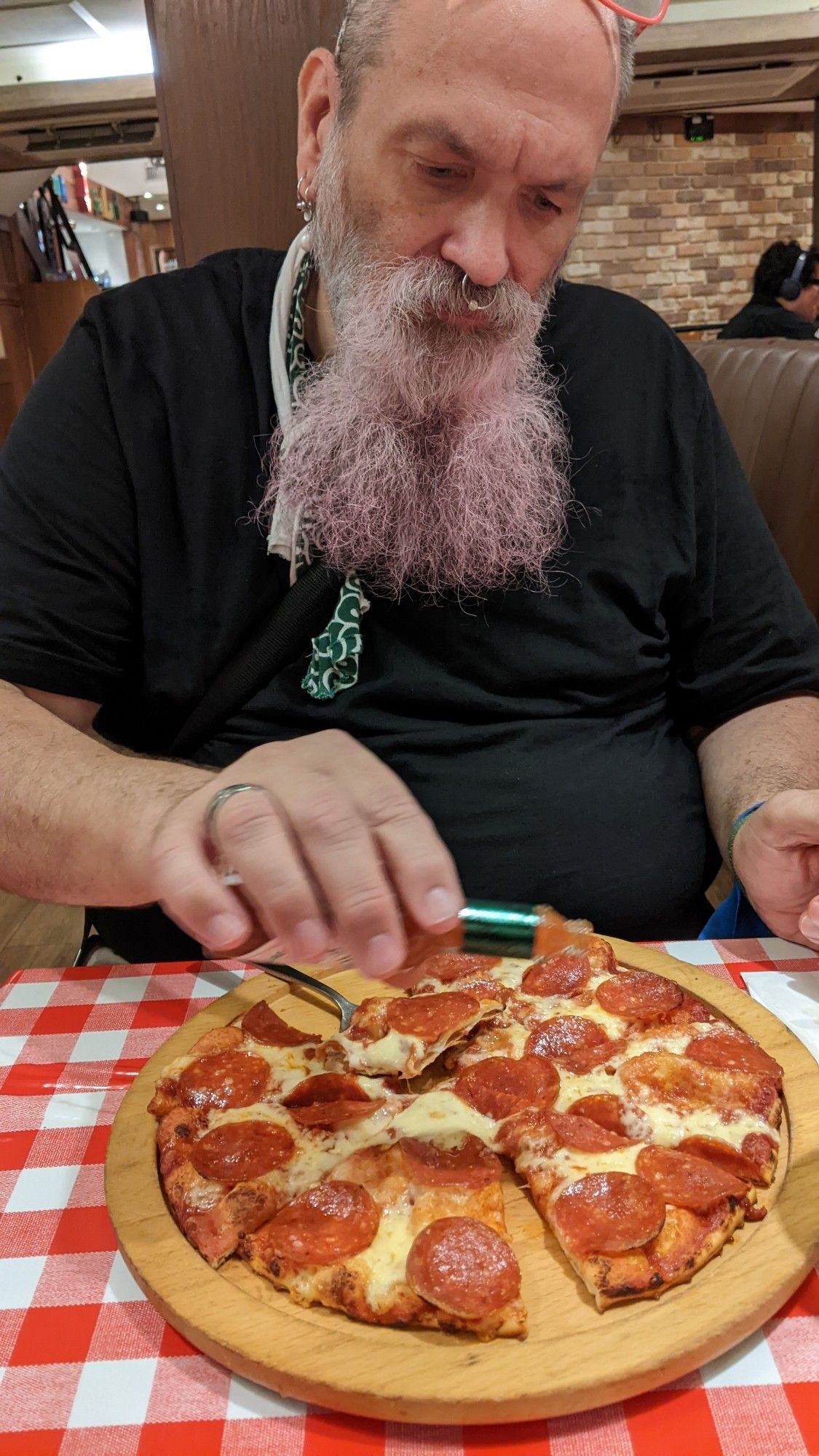 Les choosing a slice of pepperoni pizza